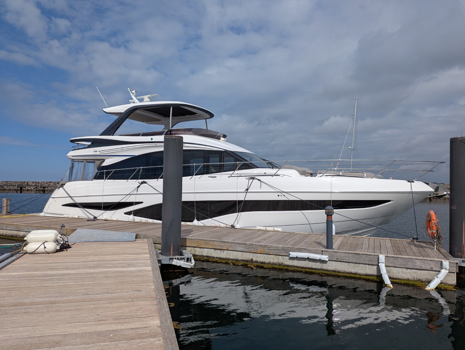 Princess F65 motor yacht alongside a marina pontoon before cargo loading